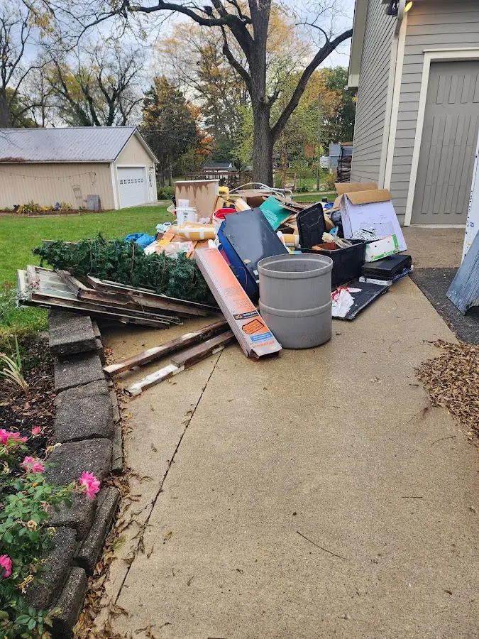 Dumpster being loaded with debris for 30 Yard Dumpster Rental in Elm Creek